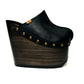 Handmade black leather wedge clogs with old-gold studs and 17 cm wenge wooden wedge by Sol Caleyo.