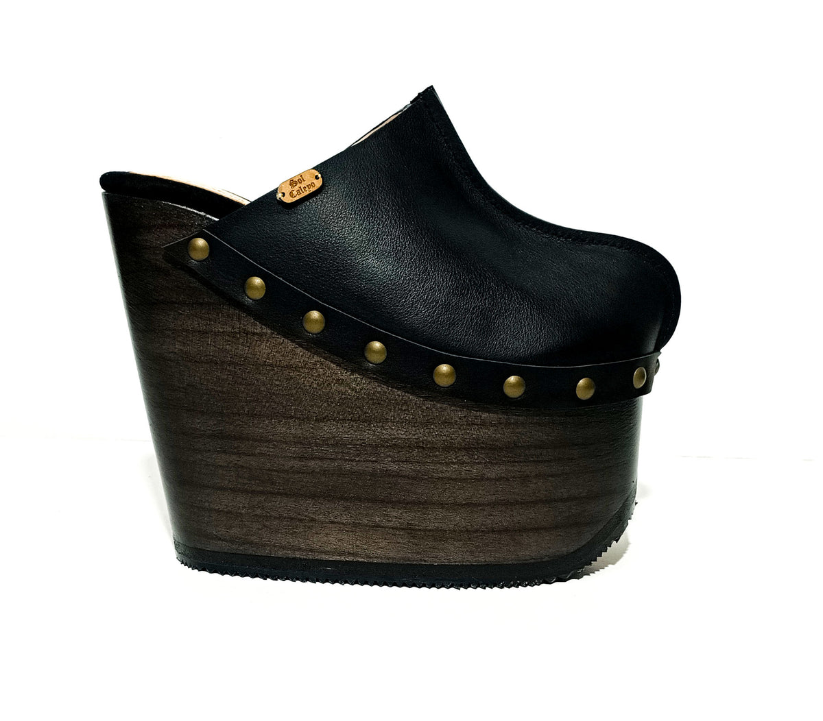 Handmade black leather wedge clogs with old-gold studs and 17 cm wenge wooden wedge by Sol Caleyo.