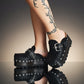Handmade black leather wedge mule clogs with silver-tone buckle, studs and 6 cm wenge wooden wedge by Sol Caleyo.