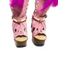 Close-up of Rhapsody Bohemia Pink Boots in premium pink suede with fringe, hand-selected feathers, and organic shells. These artisanal boho boots by Sol Caleyo feature a high hand-sculpted wooden heel and platform.