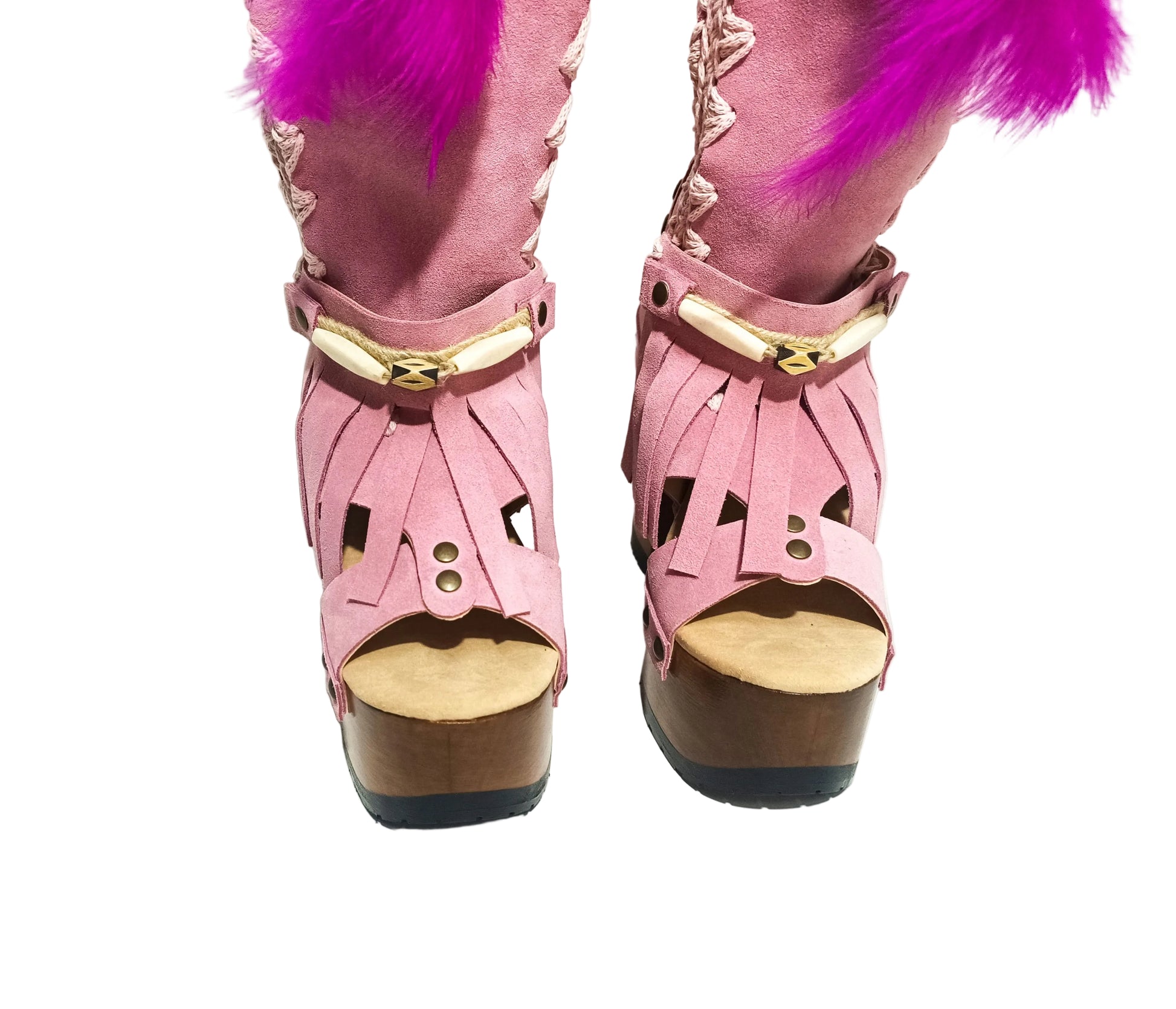 Close-up of Rhapsody Bohemia Pink Boots in premium pink suede with fringe, hand-selected feathers, and organic shells. These artisanal boho boots by Sol Caleyo feature a high hand-sculpted wooden heel and platform.