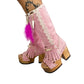 Close-up of Rhapsody Bohemia Pink Boots in premium pink suede with fringe, hand-selected feathers, and organic shells. These artisanal boho boots by Sol Caleyo feature a high hand-sculpted wooden heel and platform.