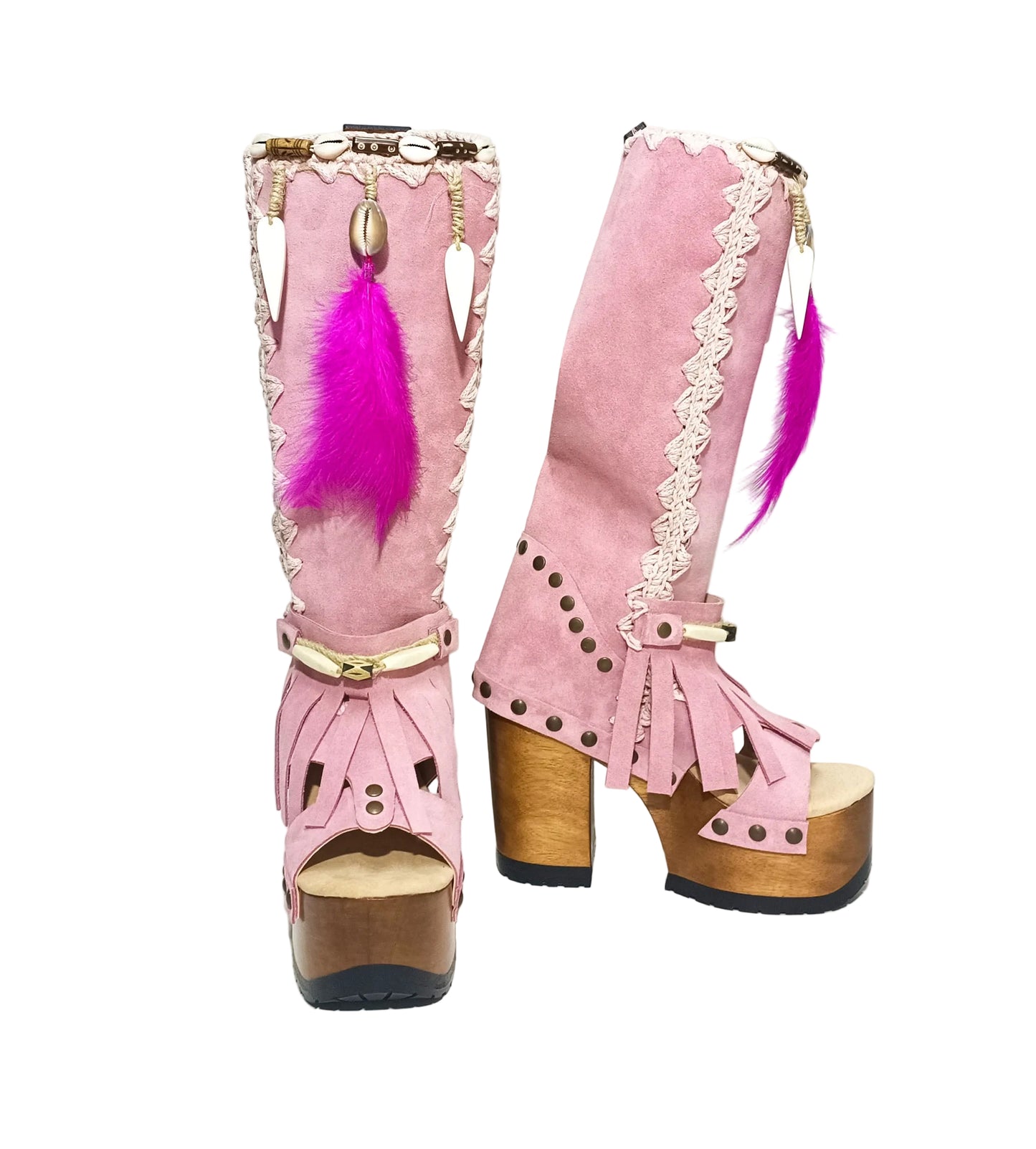 Close-up of Rhapsody Bohemia Pink Boots in premium pink suede with fringe, hand-selected feathers, and organic shells. These artisanal boho boots by Sol Caleyo feature a high hand-sculpted wooden heel and platform.