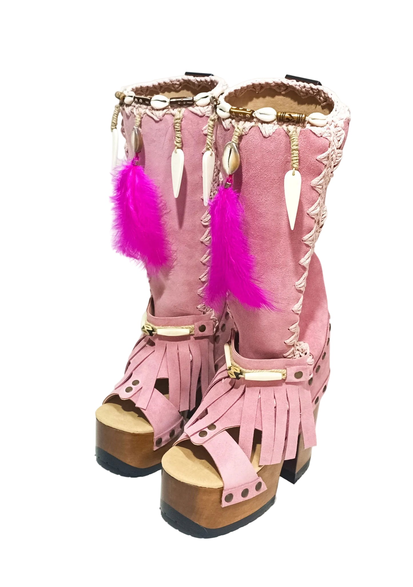Close-up of Rhapsody Bohemia Pink Boots in premium pink suede with fringe, hand-selected feathers, and organic shells. These artisanal boho boots by Sol Caleyo feature a high hand-sculpted wooden heel and platform.