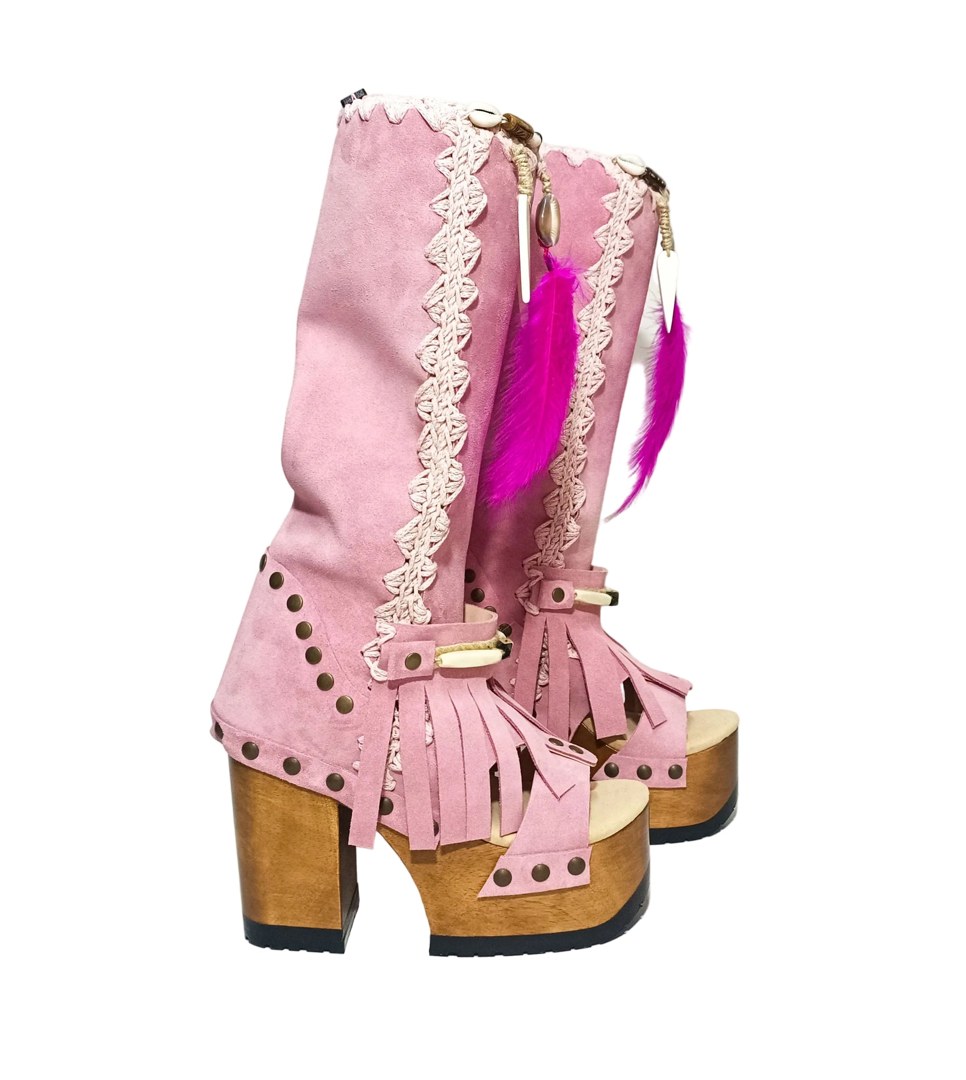 Close-up of Rhapsody Bohemia Pink Boots in premium pink suede with fringe, hand-selected feathers, and organic shells. These artisanal boho boots by Sol Caleyo feature a high hand-sculpted wooden heel and platform.