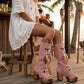 Model wearing Wild Soul Pink Boots by Sol Caleyo, handmade pink leather boho boots with high wooden platform heel in a lifestyle setting.