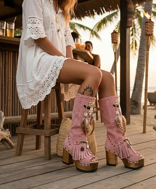 Model wearing Wild Soul Pink Boots by Sol Caleyo, handmade pink leather boho boots with high wooden platform heel in a lifestyle setting.