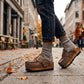 Custom made wooden sole clogs in distressed brown leather styled with wool socks and black jeans in autumn