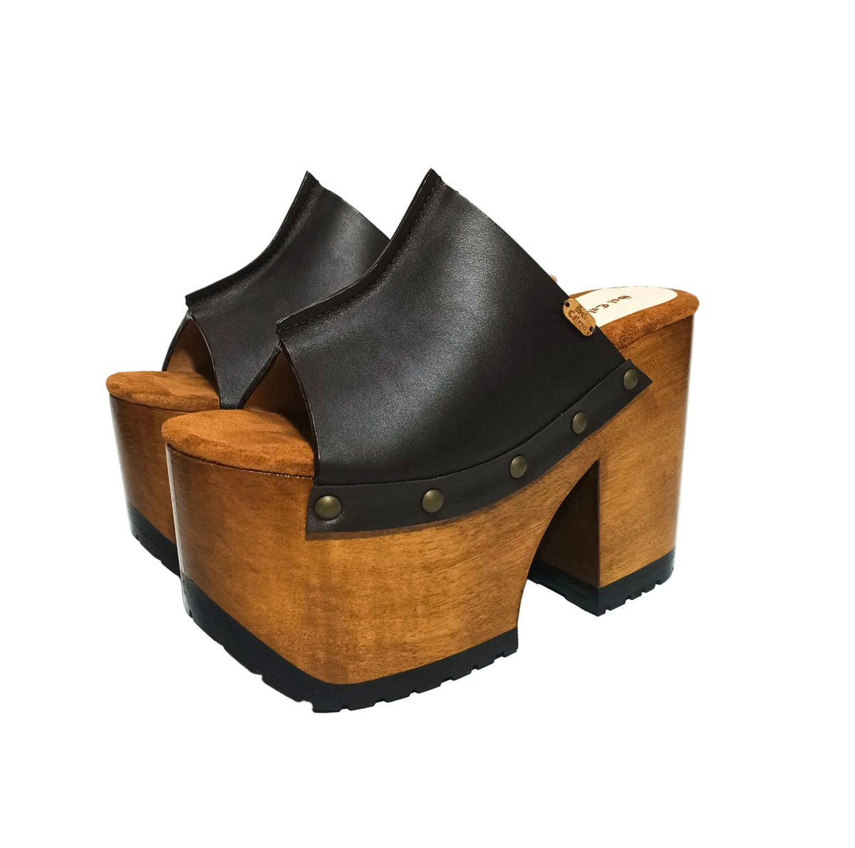 Black tractor-style rubber outsole on handmade wooden platform mule sandals for grip