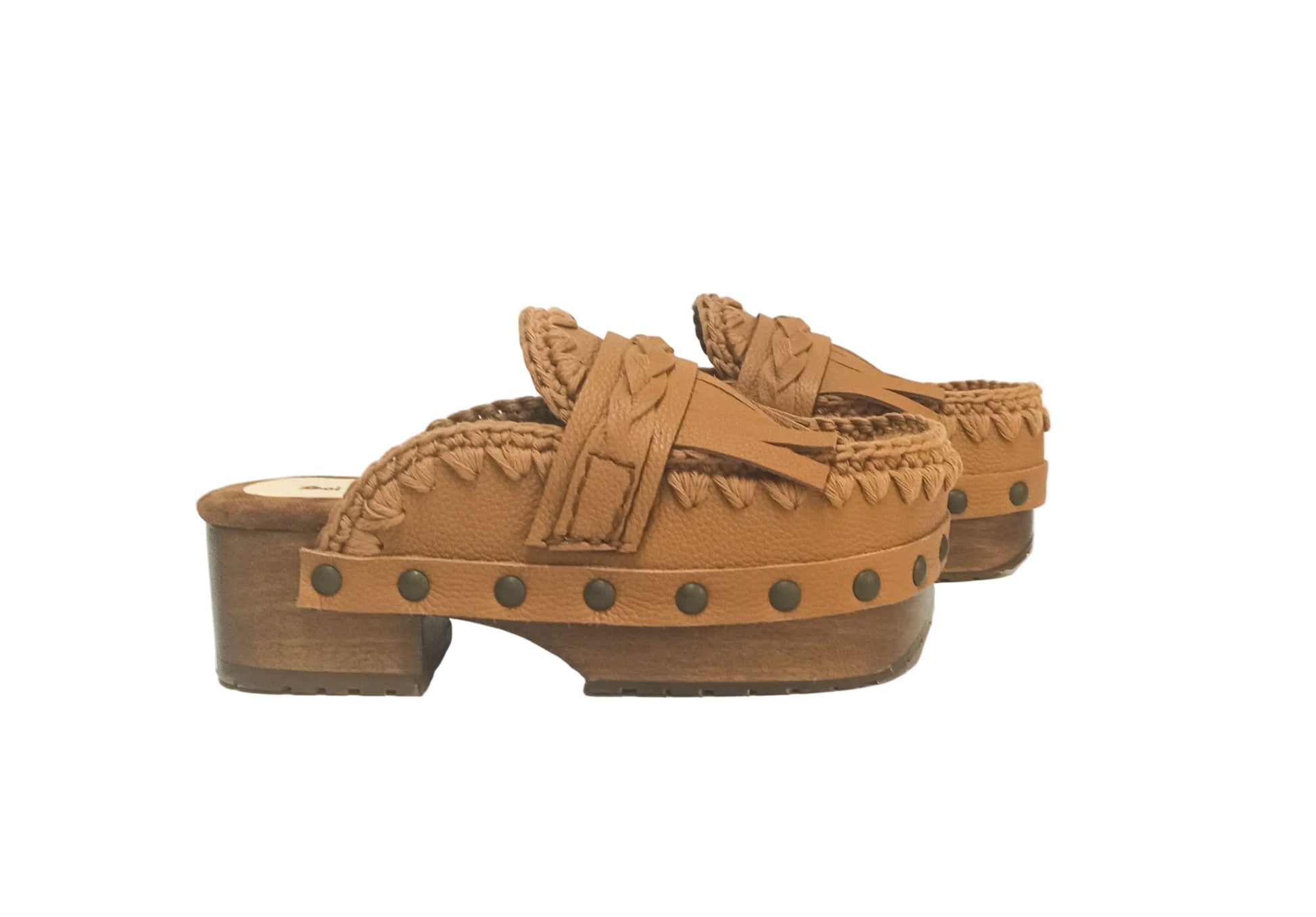 Side profile of Sol Caleyo Niza Clogs in light brown leather, showcasing hand-braided strap, crochet trim, bronze studs, and a sturdy wooden platform sole.