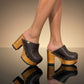 Brown leather clogs in a vintage 70s style. Super high vintage-style wooden heel. Sizes 33 to 47. High-end footwear handmade by Sol Caleyo.