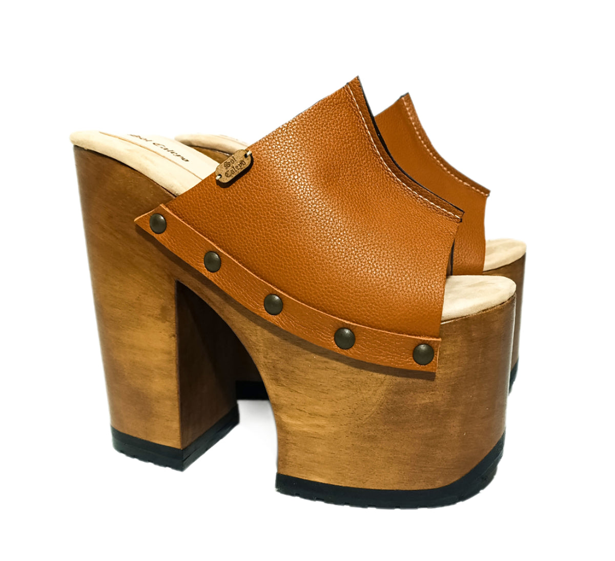 Handmade full-grain camel leather open toe platform mule sandals with wide strap, round flat old-gold studs and 17 cm natural lacquered wooden heel by Sol Caleyo.