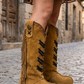 Camel handmade suede cowboy boots with long fringe, brown leather appliqués and 9 cm carved wooden heel by Sol Caleyo.