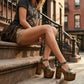 Handmade camouflage leather platform sandals with old gold-tone studs and 17 cm dark wooden heel by Sol Caleyo.