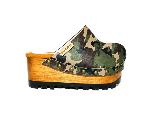 Handmade camo print open-back wedge mule clogs with antique-gold studs and 7 cm wooden wedge by Sol Caleyo.