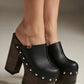 Sol Caleyo handmade black leather platform clogs with wenge wood heel and silver stud detailing being worn.