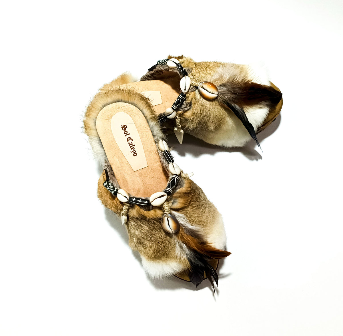 Handmade boho suede platform clogs with rabbit fur, carved bone, shells and feathers by Sol Caleyo