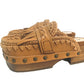 Side profile of Sol Caleyo Niza Clogs in light brown leather, showcasing hand-braided strap, crochet trim, bronze studs, and a sturdy wooden platform sole.