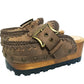 Close-up of handmade vintage leather clogs with scrolled antique brass buckle and hand-crocheted edge