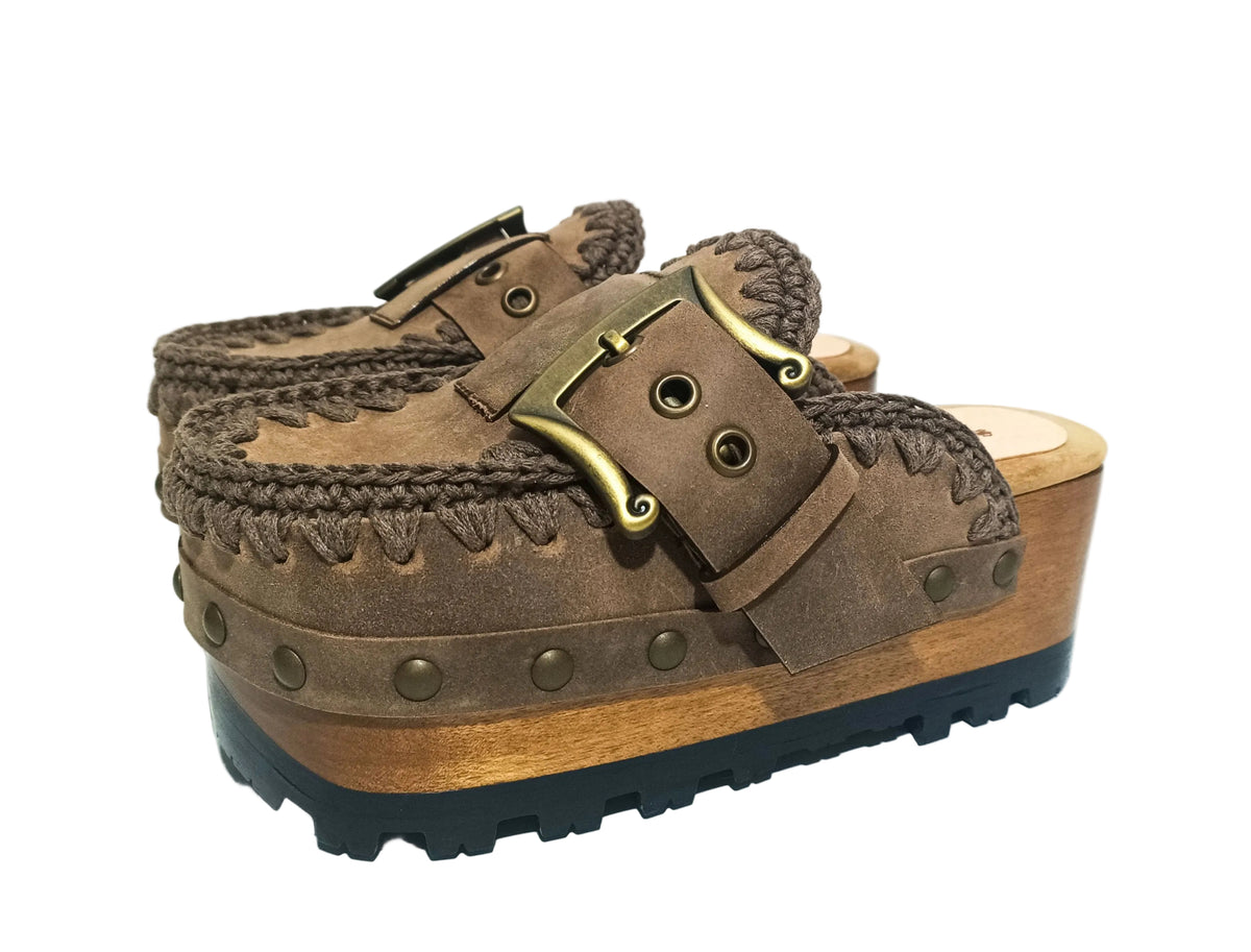 Close-up of handmade vintage leather clogs with scrolled antique brass buckle and hand-crocheted edge