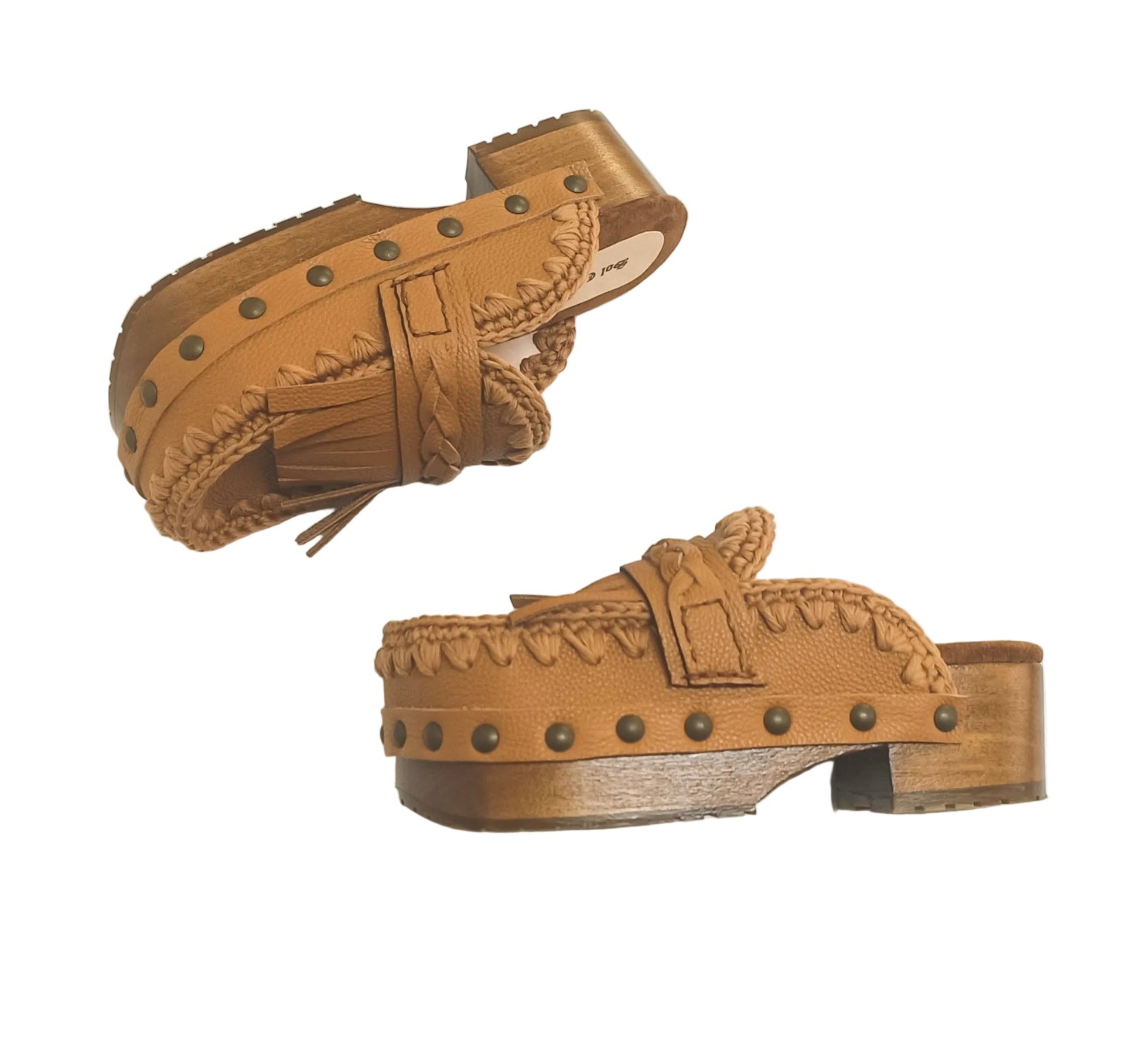 Side profile of Sol Caleyo Niza Clogs in light brown leather, showcasing hand-braided strap, crochet trim, bronze studs, and a sturdy wooden platform sole.