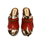 Verona Clogs by Sol Caleyo featuring light brown cow hair leather, red fringe details, and old gold studs on a high wooden platform sole with tractor grip.