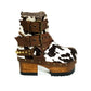 Dark brown spotted hair-on cowhide platform booties with chocolate croc-print straps, gold pyramid studs and 7 cm wooden heel by Sol Caleyo.