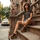 Model wearing the Brown Luxury Queen Sandals by Sol Caleyo, showcasing the 17 cm wooden platform and deep brown leather straps for a sophisticated, high-fashion look.