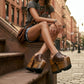 Model wearing the Brown Luxury Queen Sandals by Sol Caleyo, showcasing the 17 cm wooden platform and deep brown leather straps for a sophisticated, high-fashion look.