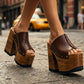 Model wearing the Brown Luxury Queen Sandals by Sol Caleyo, showcasing the 17 cm wooden platform and deep brown leather straps for a sophisticated, high-fashion look.