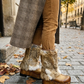 Person wearing handmade beige leather and fur platform boots, showing fit and bohemian style.