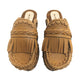 Side profile of Sol Caleyo Niza Clogs in light brown leather, showcasing hand-braided strap, crochet trim, bronze studs, and a sturdy wooden platform sole.