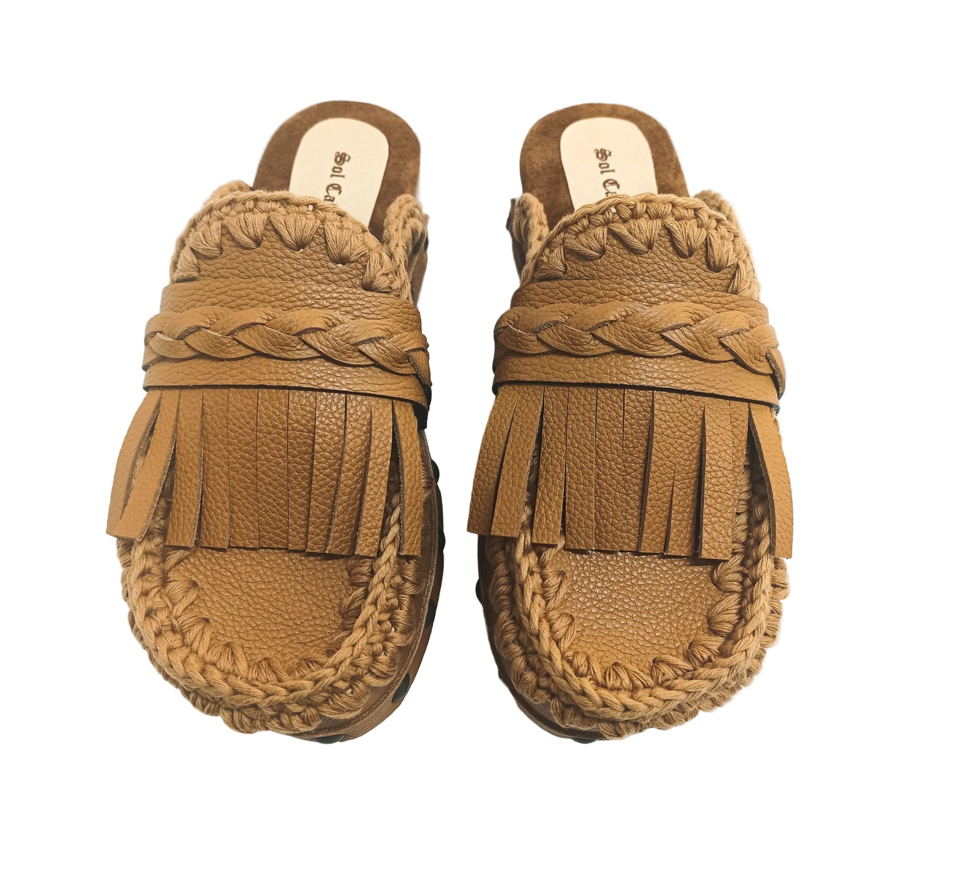 Side profile of Sol Caleyo Niza Clogs in light brown leather, showcasing hand-braided strap, crochet trim, bronze studs, and a sturdy wooden platform sole.