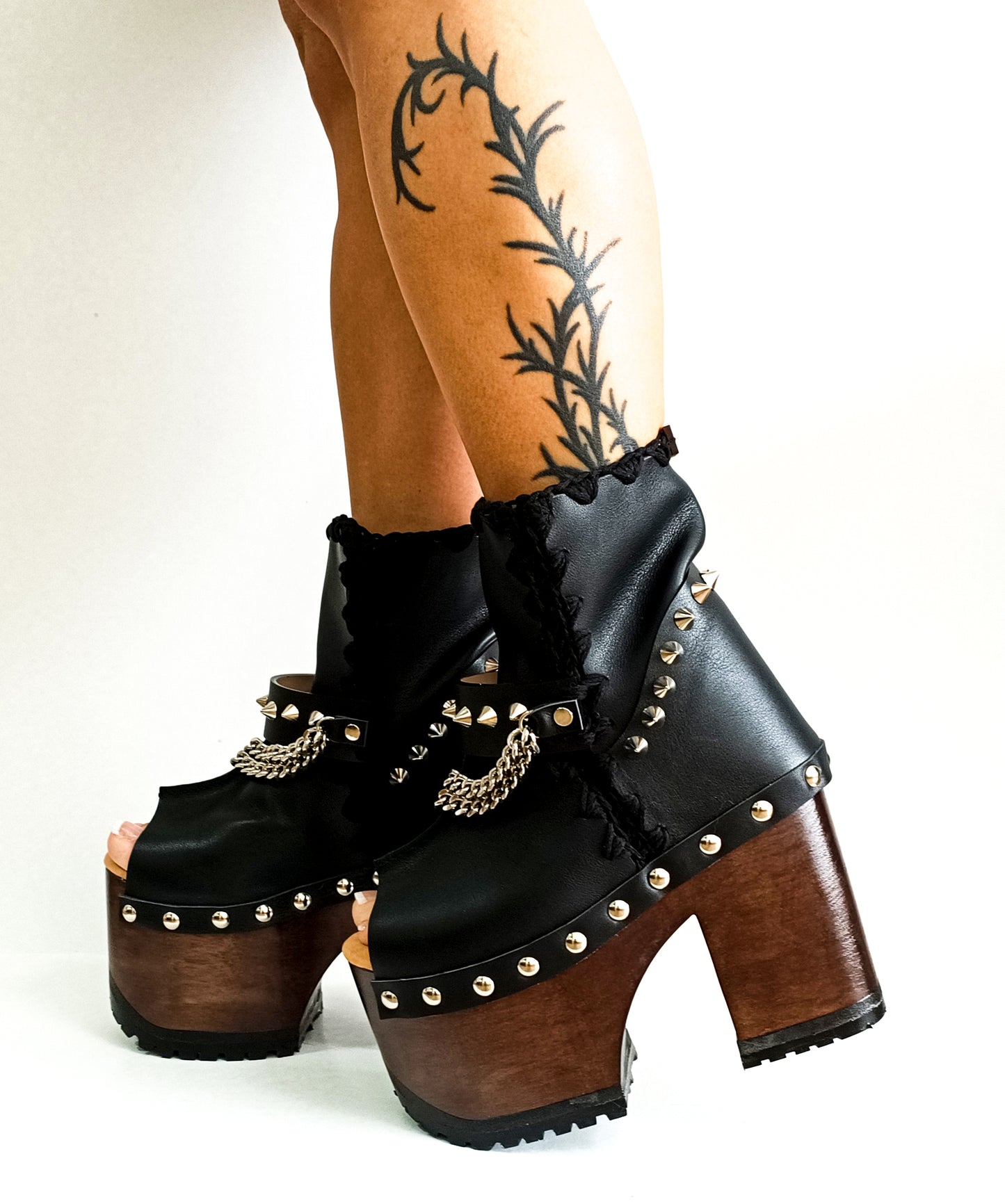 Black leather platform boot. Leather boot with super high wooden heel. Leather peep toe boot decorated with studs and silver chains. Platform boots with platform heel. Sizes 34 to 47. High quality leather shoes handmade by sol Caleyo. Sustainable fashion.