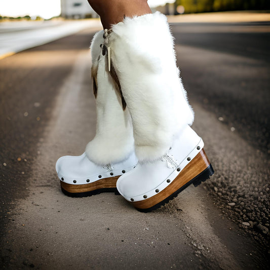 White fur boots with wooden wedge. White bohemian style leather boots. Handmade clogs shoes. White fur boots decorated with feathers, natural shells and horns. High-end handmade footwear by Sol Caleyo. Handmade Furry Shoes.