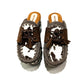 Moccasin style cowhide leather clogs, decorated with fringed laces. Moccasin style leather mules. High-end footwear handmade by Sol Caleyo.