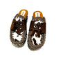 Moccasin style cowhide leather clogs, decorated with fringed laces. Moccasin style leather mules. High-end footwear handmade by Sol Caleyo.