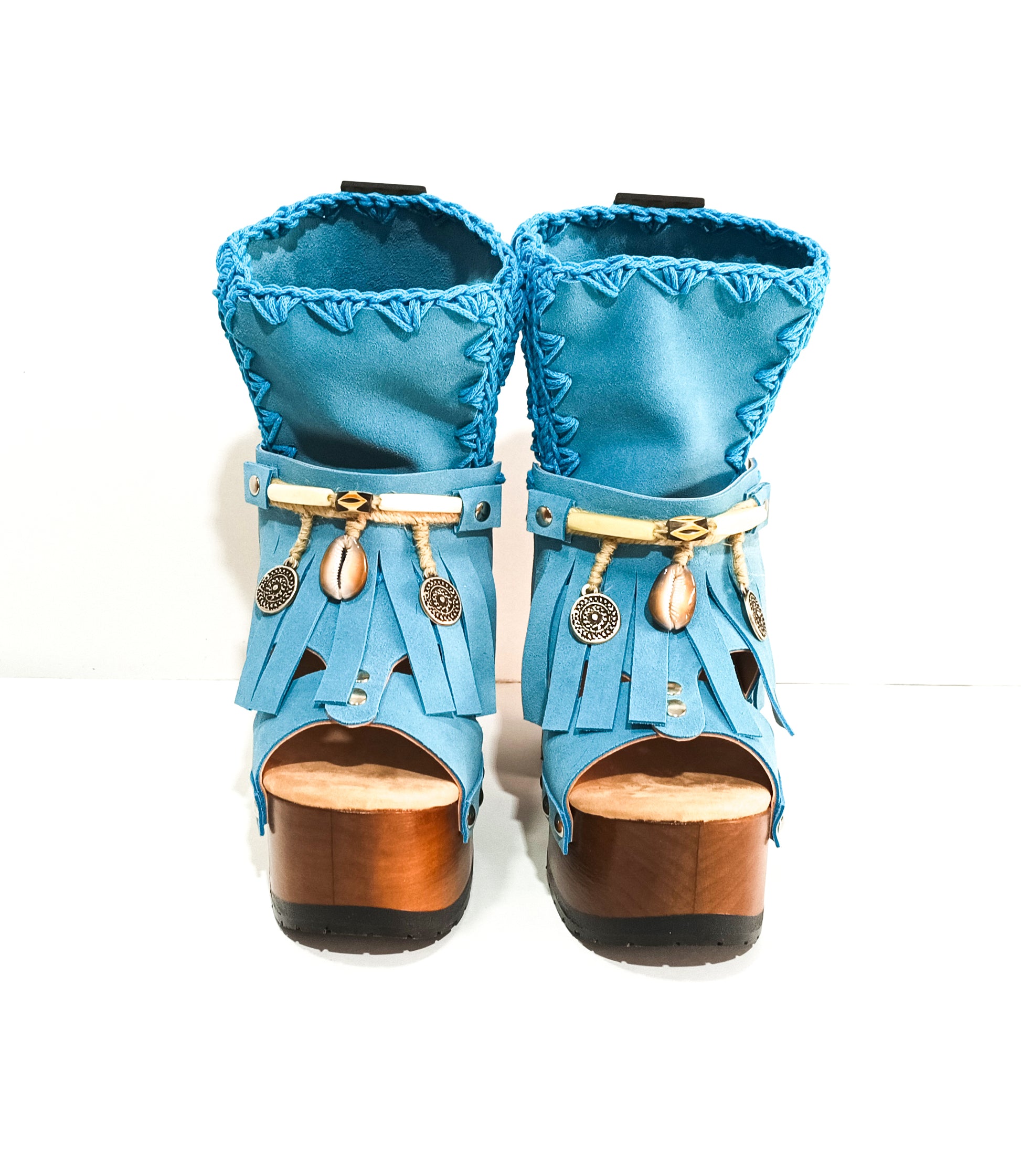 Bohemian style turquoise suede leather boots. Turquoise boots with wooden heel. Turquoise boots decorated with coins, horns and feathers, Boho Chic style. High-end handmade footwear by Sol Caleyo.