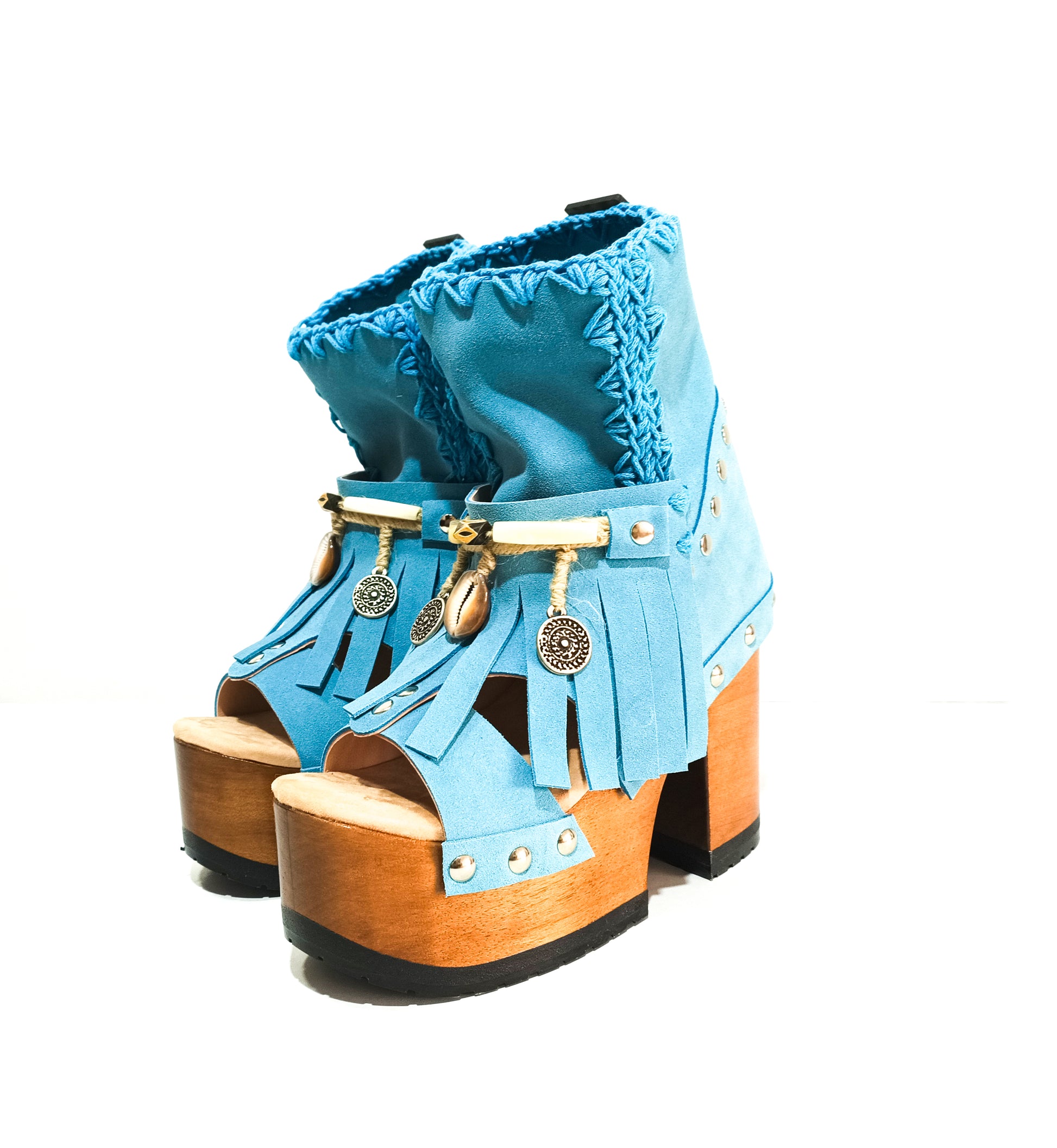 Bohemian style turquoise suede leather boots. Turquoise boots with wooden heel. Turquoise boots decorated with coins, horns and feathers, Boho Chic style. High-end handmade footwear by Sol Caleyo.