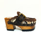 Snake leather mule. Wooden clogs with snake leather. Oxford style clogs with buckle. High-end handmade footwear by Sol Caleyo.