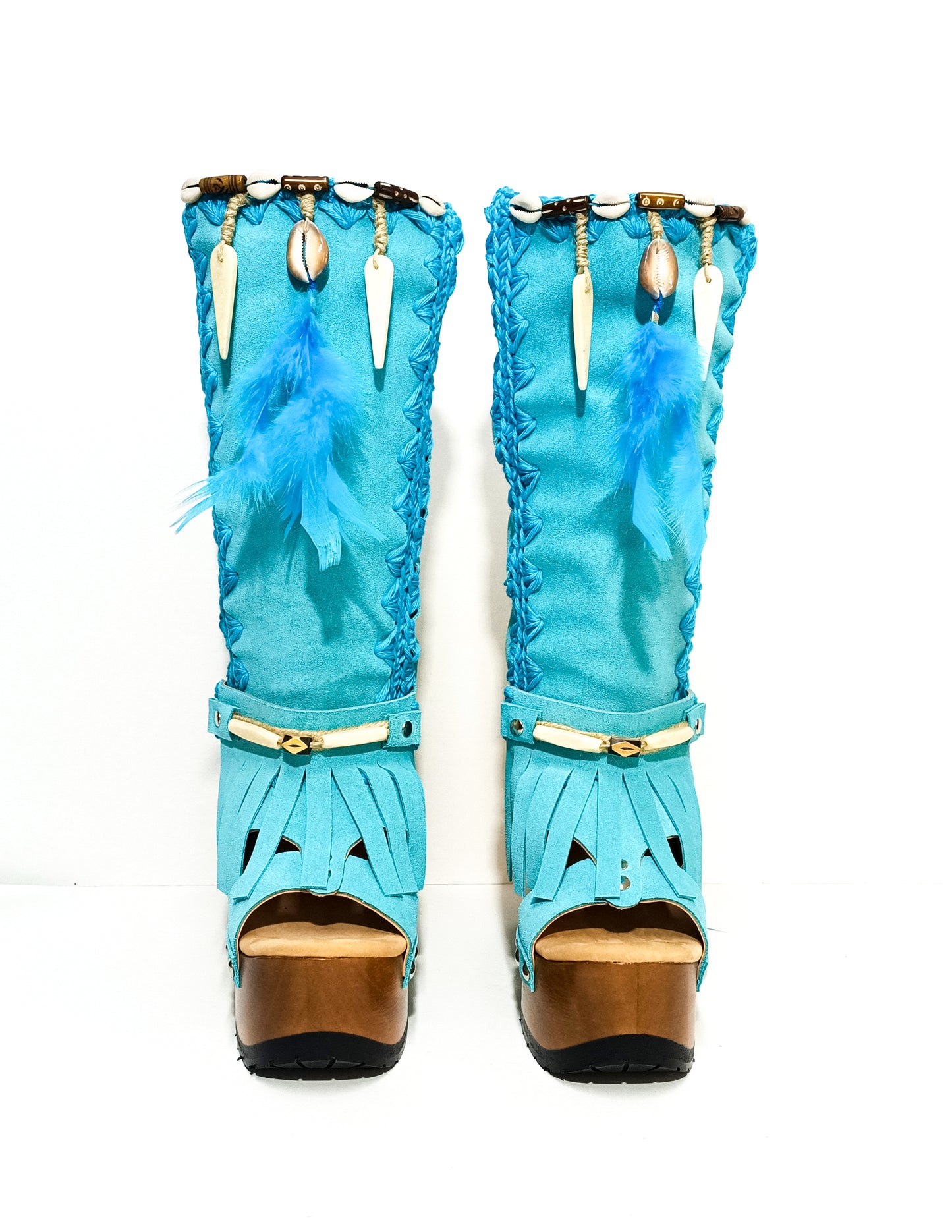 Turquoise bohemian-style boots, handmade. Platform boots with wooden heel. Turquoise bohemian-style boots decorated with feathers, shells and carved bone. High-end footwear handmade by Sol Caleyo.