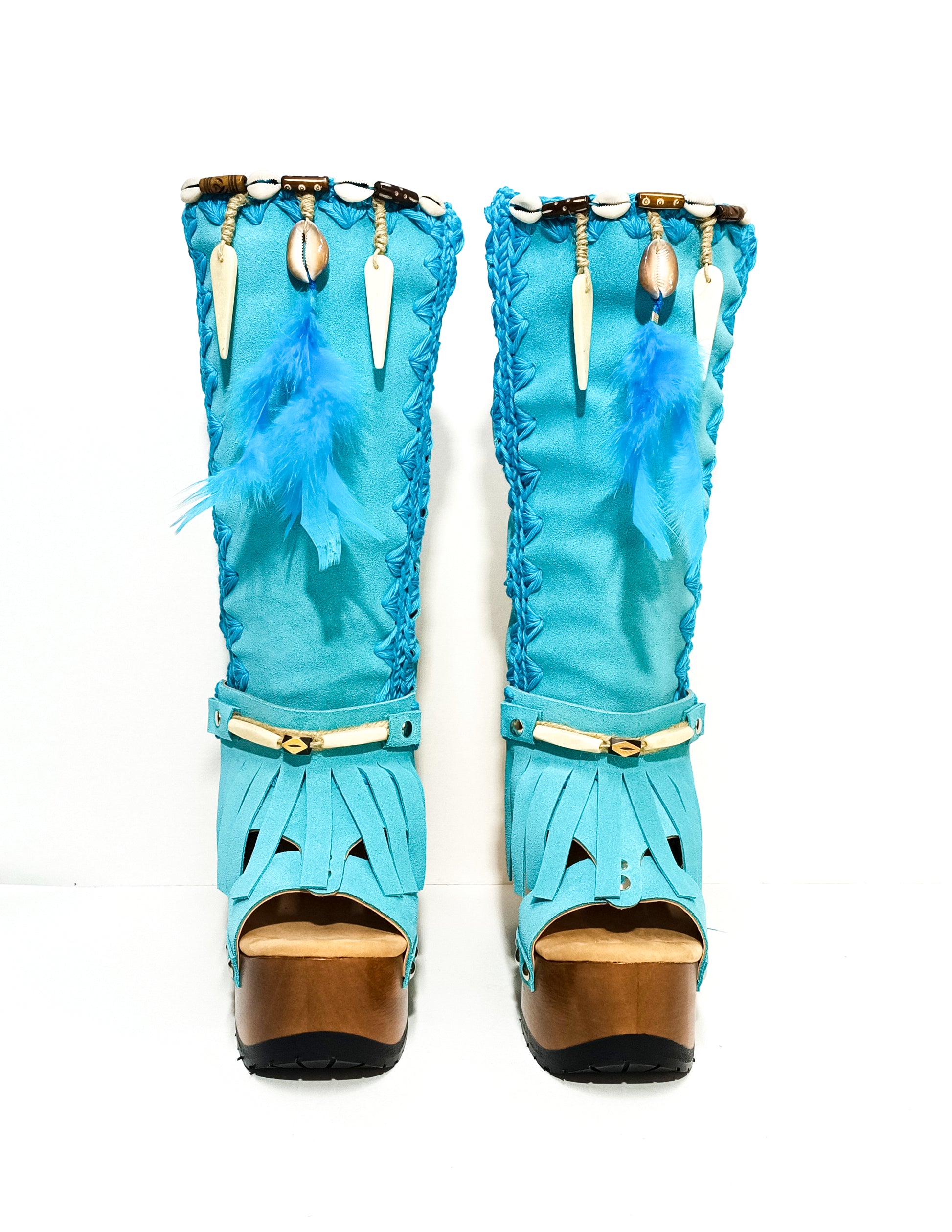 Turquoise bohemian-style boots, handmade. Platform boots with wooden heel. Turquoise bohemian-style boots decorated with feathers, shells and carved bone. High-end footwear handmade by Sol Caleyo.