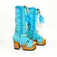 Turquoise bohemian-style boots, handmade. Platform boots with wooden heel. Turquoise bohemian-style boots decorated with feathers, shells and carved bone. High-end footwear handmade by Sol Caleyo.