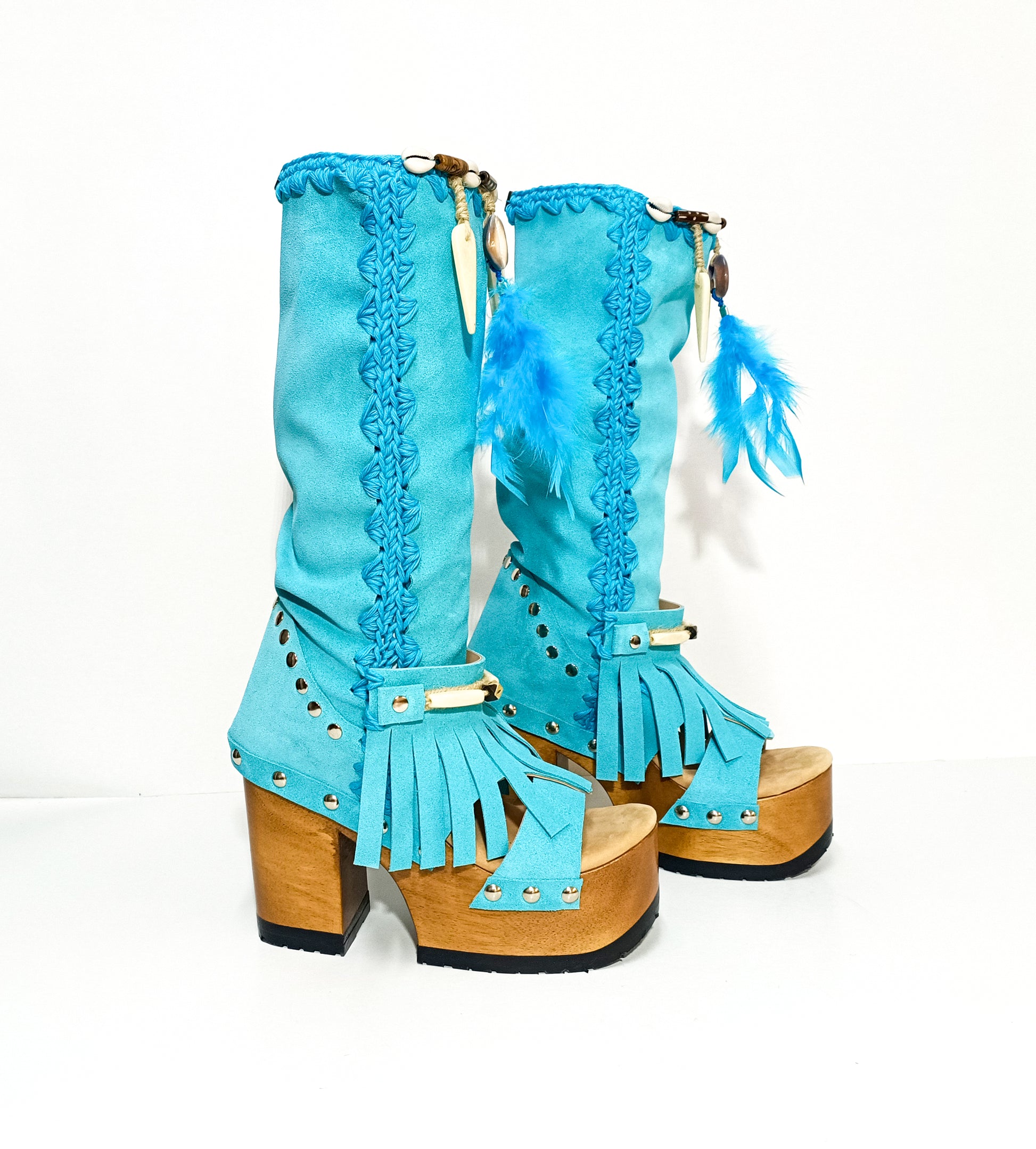 Turquoise bohemian-style boots, handmade. Platform boots with wooden heel. Turquoise bohemian-style boots decorated with feathers, shells and carved bone. High-end footwear handmade by Sol Caleyo.