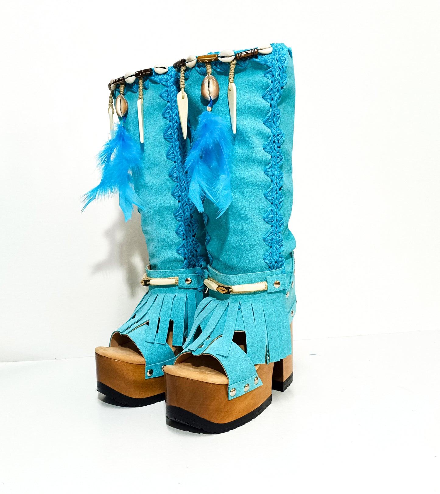 Turquoise bohemian-style boots, handmade. Platform boots with wooden heel. Turquoise bohemian-style boots decorated with feathers, shells and carved bone. High-end footwear handmade by Sol Caleyo.