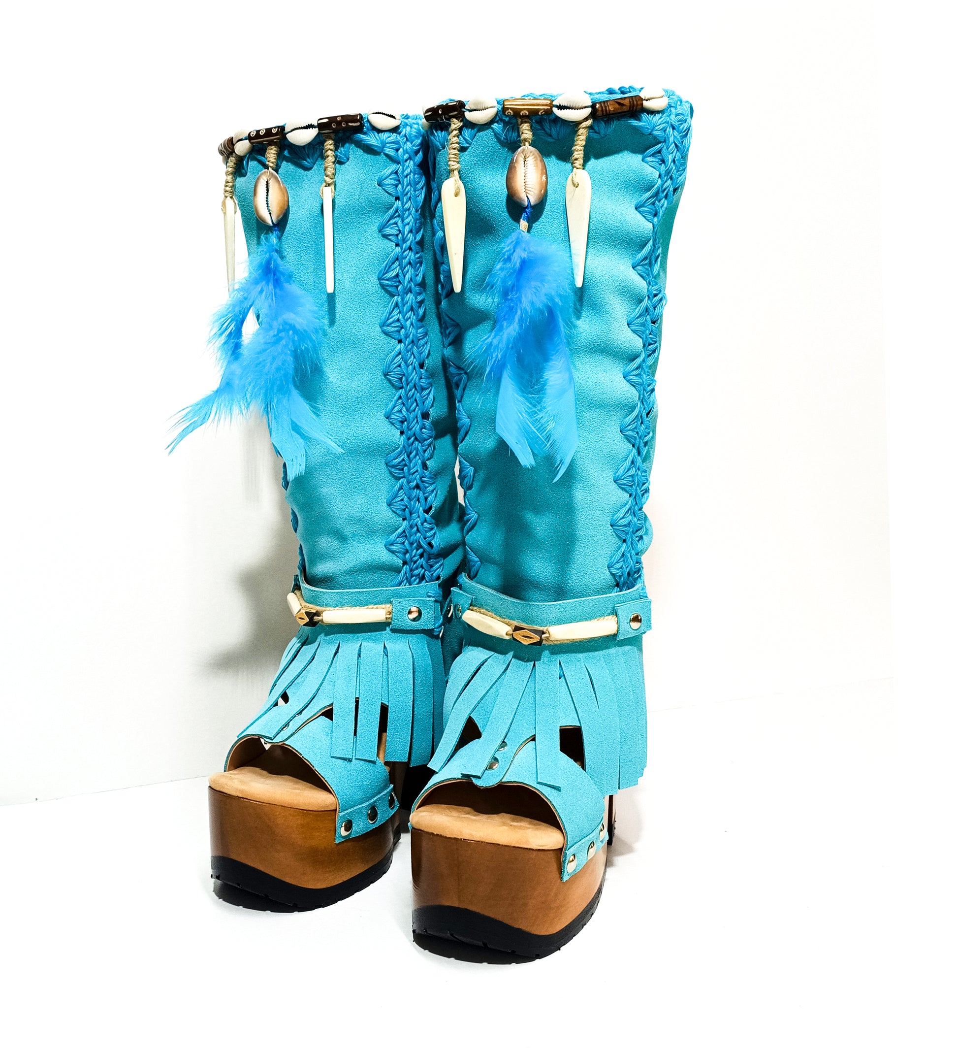 Turquoise bohemian-style boots, handmade. Platform boots with wooden heel. Turquoise bohemian-style boots decorated with feathers, shells and carved bone. High-end footwear handmade by Sol Caleyo.