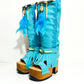 Turquoise bohemian-style boots, handmade. Platform boots with wooden heel. Turquoise bohemian-style boots decorated with feathers, shells and carved bone. High-end footwear handmade by Sol Caleyo.