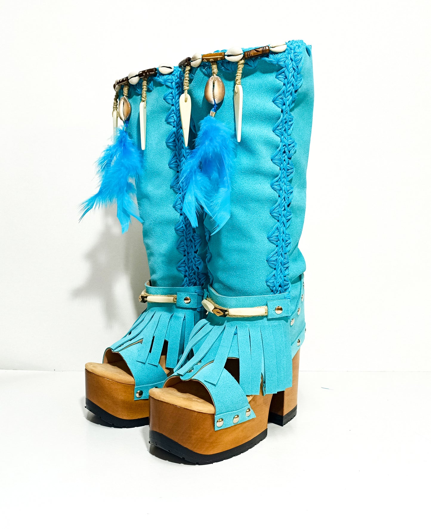 Turquoise bohemian-style boots, handmade. Platform boots with wooden heel. Turquoise bohemian-style boots decorated with feathers, shells and carved bone. High-end footwear handmade by Sol Caleyo.