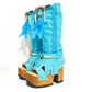 Turquoise bohemian-style boots, handmade. Platform boots with wooden heel. Turquoise bohemian-style boots decorated with feathers, shells and carved bone. High-end footwear handmade by Sol Caleyo.