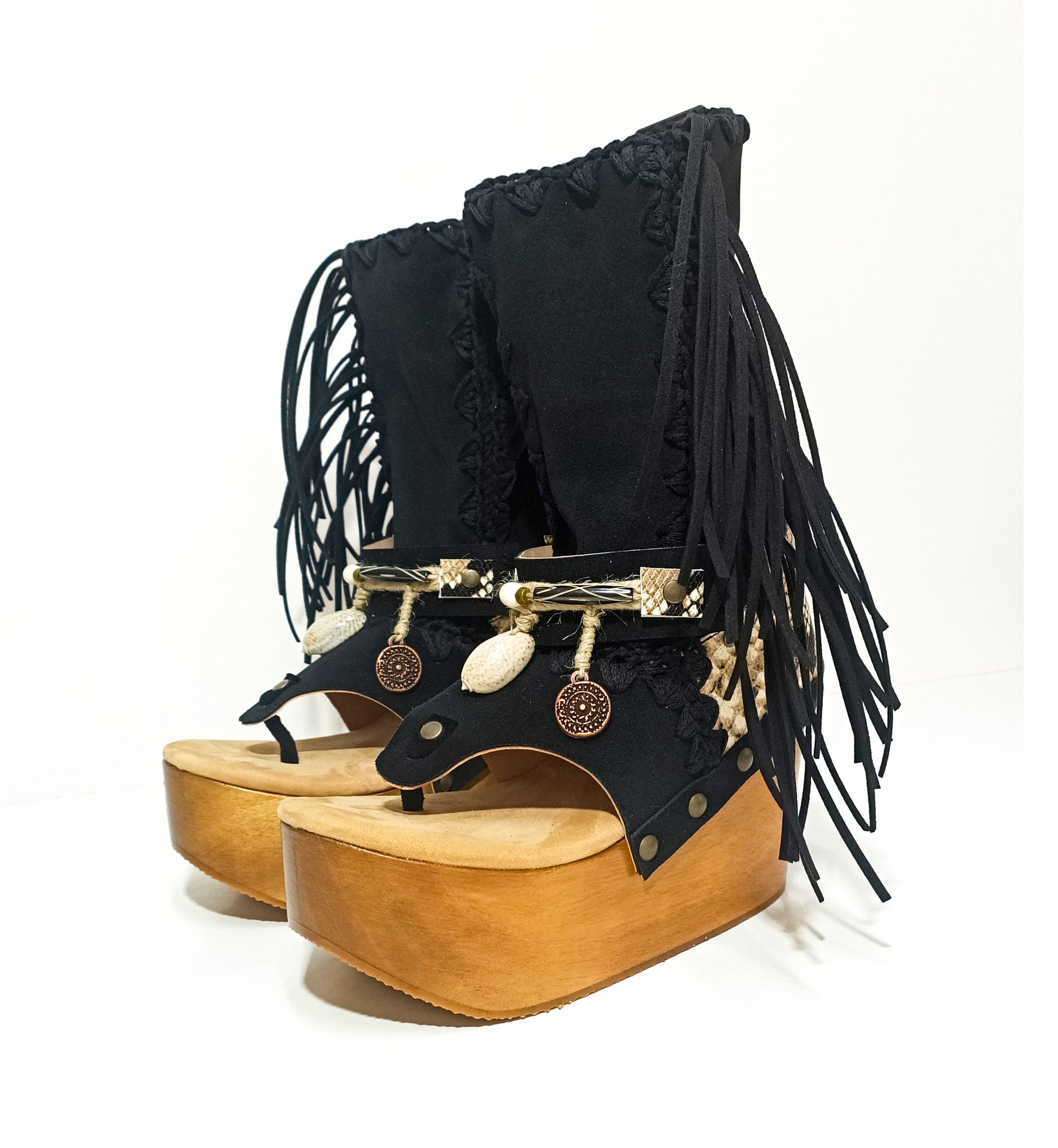Leather clog boot with wooden wedge flip flop style. Leather flip flop style boot decorated with shells, coins and fringes which gives it an authentic Boho style. Leather flip flop with wooden wedge. Bohemian style leather boot. Sizes 34 to 47. High quality leather footwear handmade by sol Caleyo. Sustainable fashion.